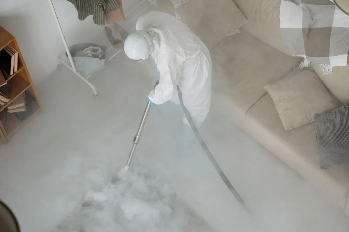 Biohazard cleanup technician in protective equipment, Godley, TX